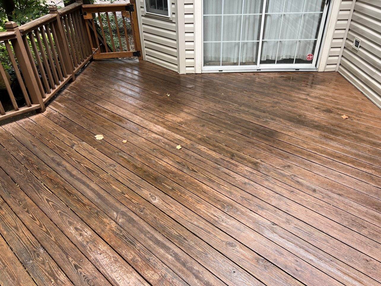 The same deck after washing, brightening, and staining — same structure, years of life recovered.