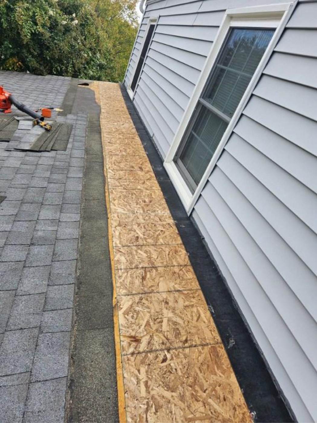 A tear-off with new OSB decking being laid — widespread deck damage is one of the strongest arguments for replacement.